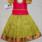 Kids pattu pavadai set with red semi silk top and green bridal silk skirt from Sri Thulir Tex