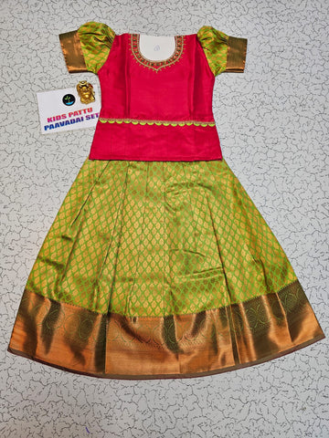 Kids Pattu Pavadai set with red stone-work top and green zari woven skirt from Sri Thulir Tex.