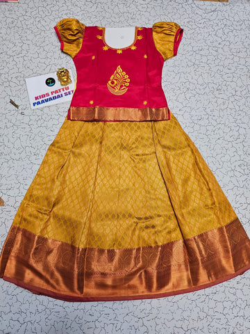 Kids pattu pavadai set with red semi-silk top and mustard gold bridal silk skirt from Sri Thulir Tex.