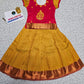 Kids pattu pavadai set with red semi-silk top and mustard gold bridal silk skirt by Sri Thulir Tex