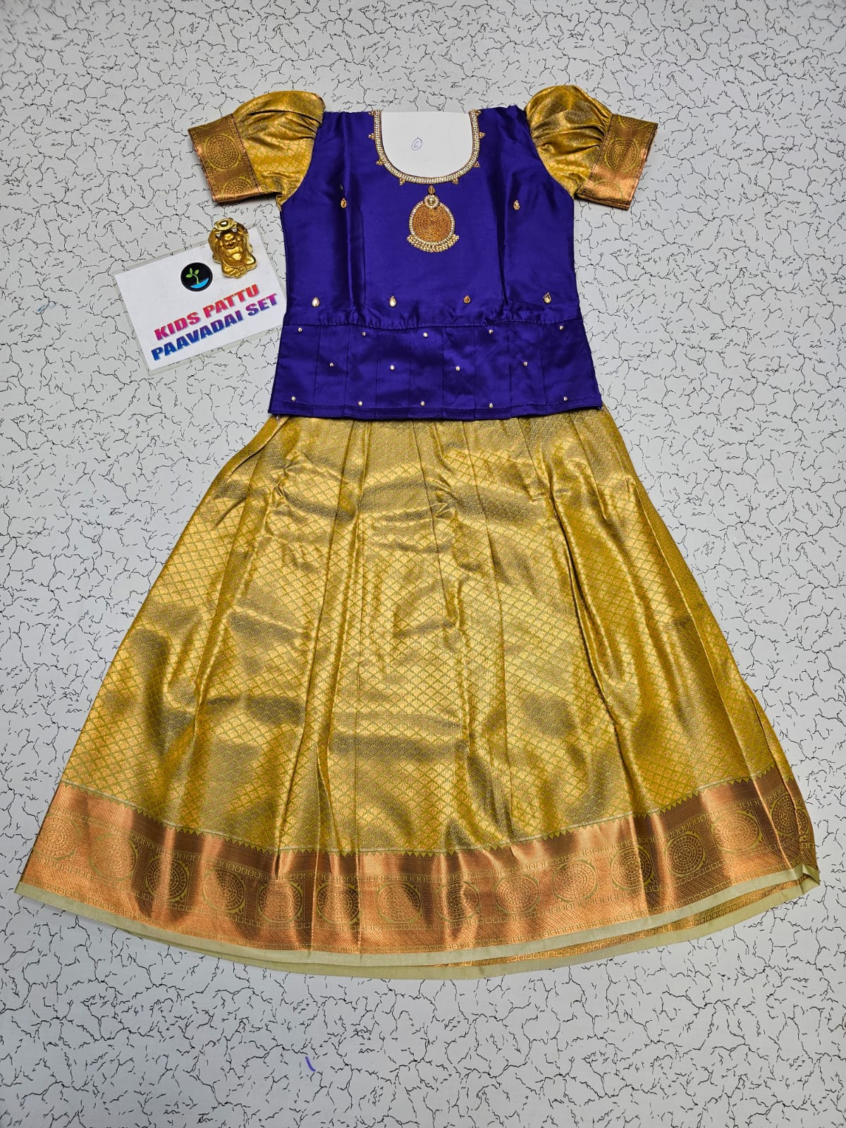 Kids Pattu Pavadai set with royal blue stone-work top and golden zari woven skirt from Sri Thulir Tex.