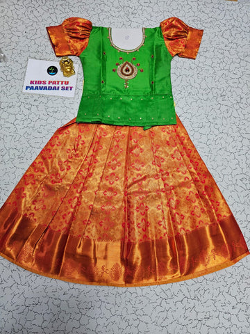 Kids pattu pavadai set with green semi silk top and orange bridal silk skirt by Sri Thulir Tex