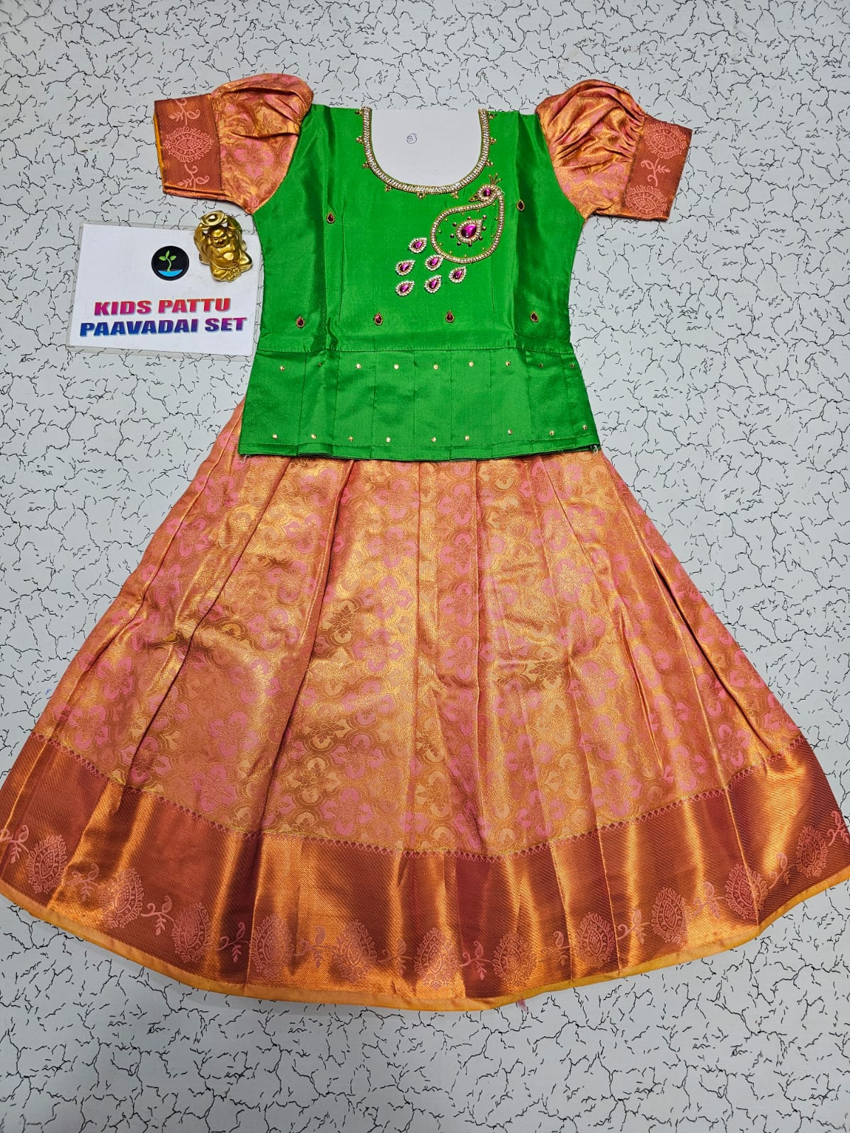 Kids pattu pavadai set with green semi silk top and peach-gold bridal silk skirt by Sri Thulir Tex