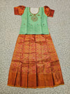 Kids pattu pavadai set with mint green semi silk top and orange bridal silk skirt by Sri Thulir Tex