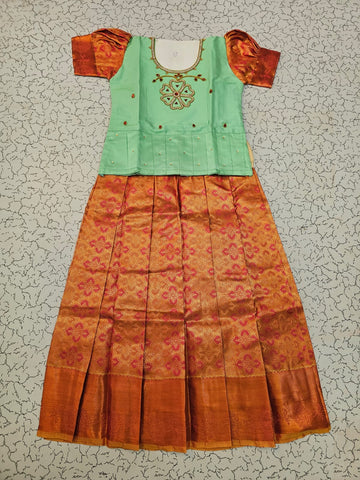 Kids pattu pavadai set with mint green semi silk top and orange bridal silk skirt by Sri Thulir Tex