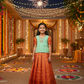 Kids pattu pavadai set with mint green semi silk top and orange bridal silk skirt by Sri Thulir Tex