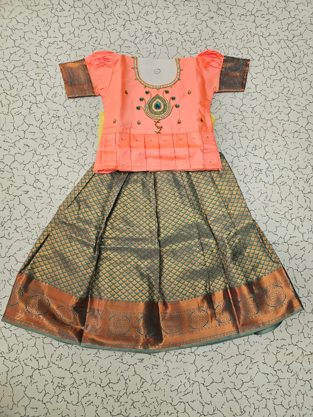 Kids pattu pavadai set with peach semi silk top and green bridal silk skirt by Sri Thulir Tex