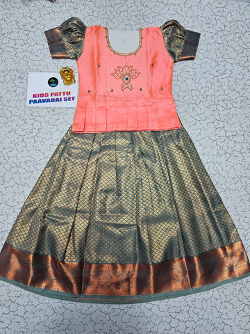 Kids pattu pavadai set with peach semi silk top and green bridal silk skirt by Sri Thulir Tex