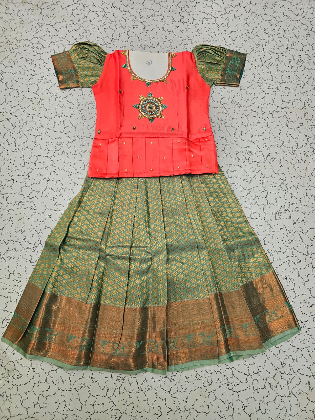Kids pattu pavadai set with pink semi silk top and green bridal silk skirt by Sri Thulir Tex