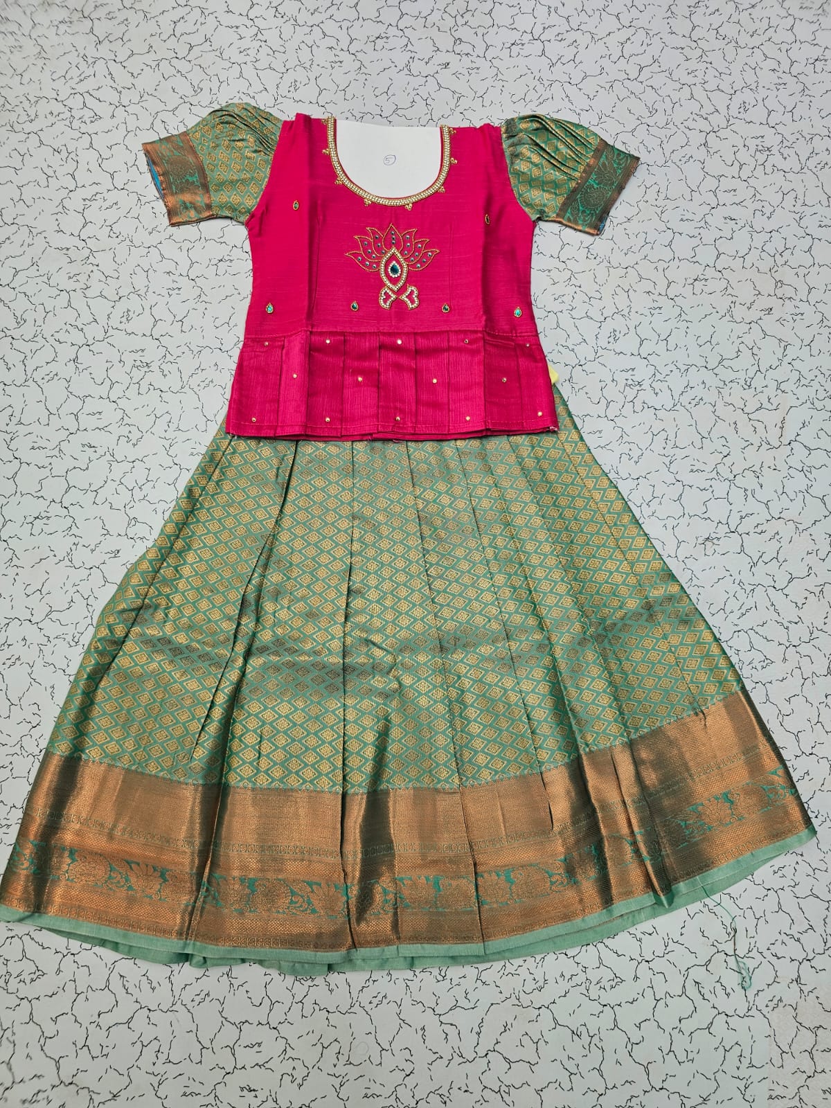 Kids pattu pavadai set with pink semi silk top and green bridal silk skirt by Sri Thulir Tex