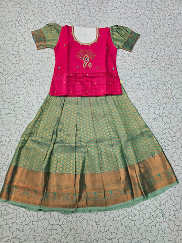 Kids pattu pavadai set with pink semi silk top and green bridal silk skirt by Sri Thulir Tex