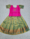 Kids pattu pavadai set with pink semi silk top and green bridal silk skirt by Sri Thulir Tex