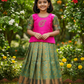 Kids pattu pavadai set with pink semi silk top and green bridal silk skirt by Sri Thulir Tex
