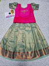Kids pattu pavadai set with pink semi silk top and green bridal silk skirt by Sri Thulir Tex