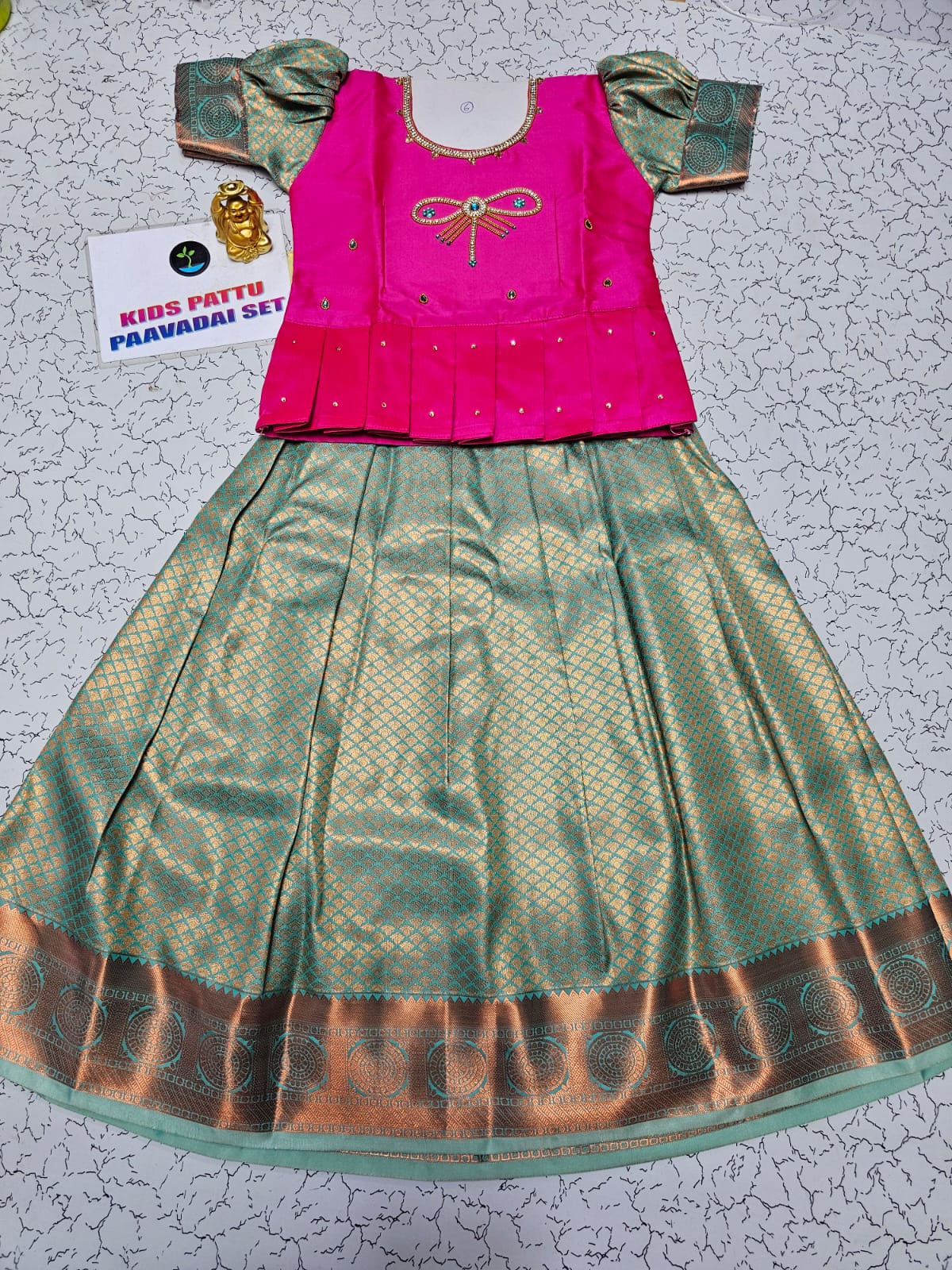 Kids pattu pavadai set with pink semi silk top and green bridal silk skirt by Sri Thulir Tex