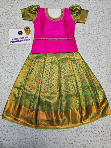 Kids pink blouse and green silk pattu pavadai set with stonework and puff sleeves