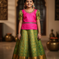 Kids pink blouse and green silk pattu pavadai set with stonework and puff sleeves