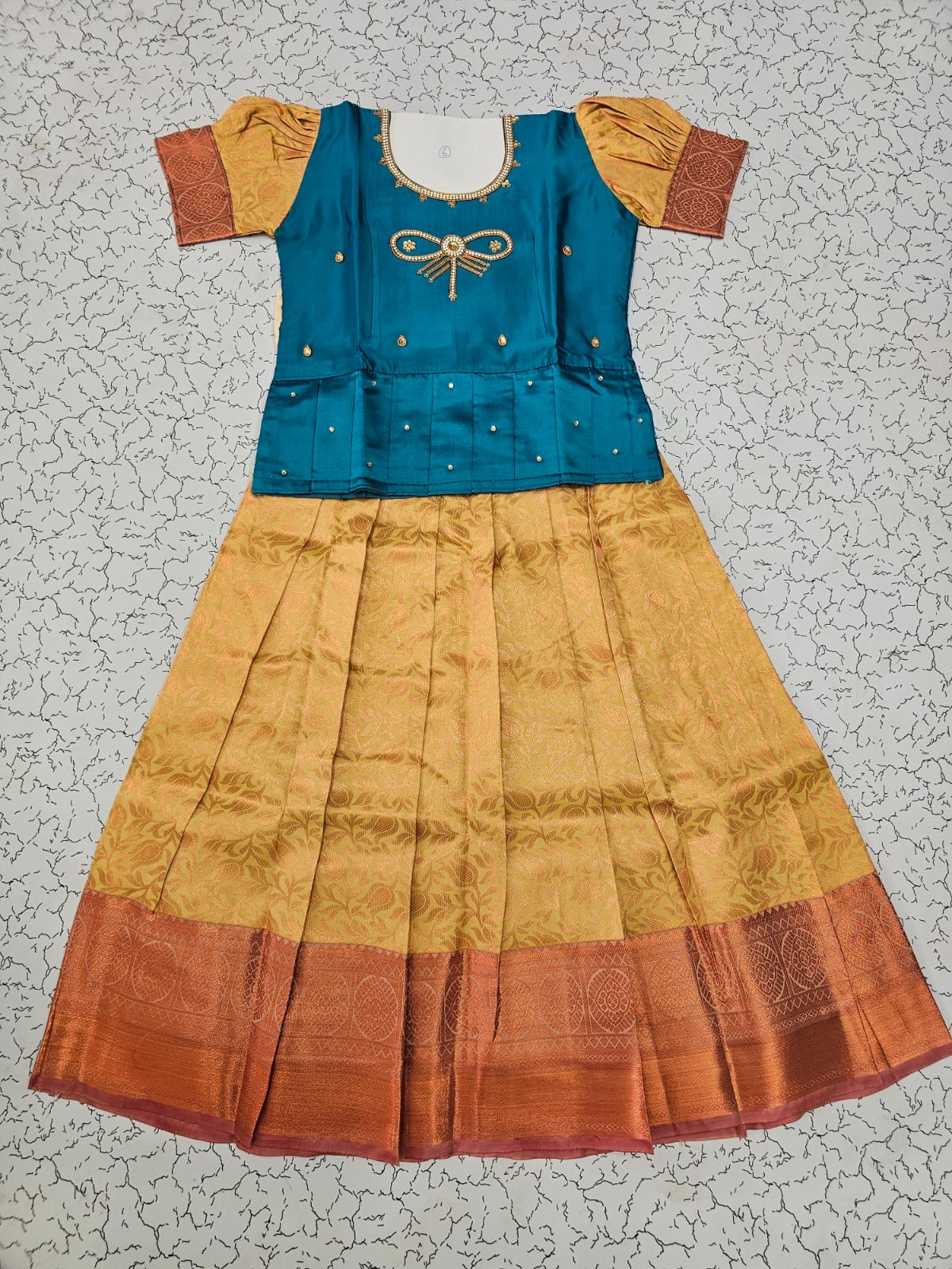 Kids pattu pavadai set with teal blue semi silk top and cream bridal silk skirt by Sri Thulir Tex