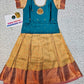 Kids teal blue blouse with stone work and copper gold silk pattu pavadai set by Sri Thulir Tex
