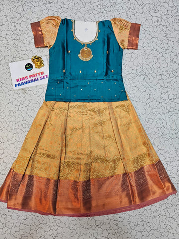 Kids teal blue blouse with stone work and copper gold silk pattu pavadai set by Sri Thulir Tex