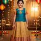 Kids teal blue blouse with stone work and copper gold silk pattu pavadai set by Sri Thulir Tex