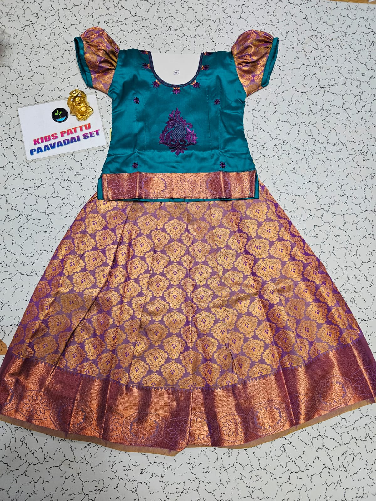 Kids teal green and purple pattu pavadai set with puff sleeve blouse and zari woven skirt from Sri Thulir Tex
