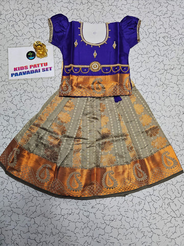 Kids Pattu Pavadai set with violet stone-work top and beige zari woven skirt from Sri Thulir Tex.