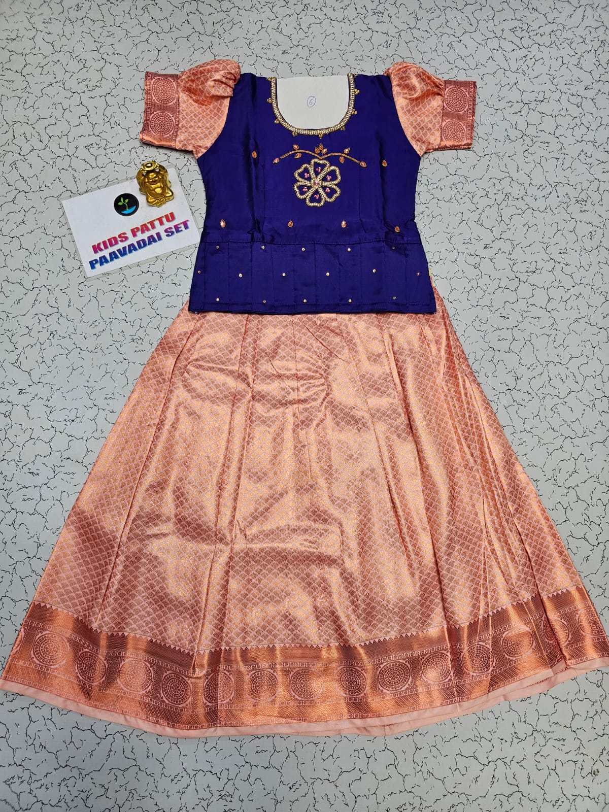 Kids Pattu Pavadai set with violet stone-work top and peach zari woven skirt from Sri Thulir Tex.