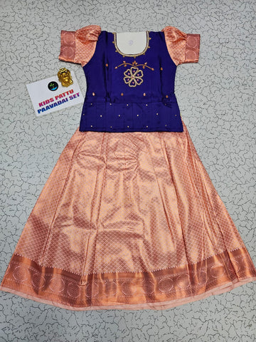 Kids Pattu Pavadai set with violet stone-work top and peach zari woven skirt from Sri Thulir Tex.