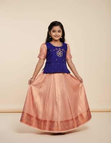 Kids Pattu Pavadai set with violet stone-work top and peach zari woven skirt from Sri Thulir Tex.