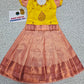 Kids yellow and peach pattu pavadai set with puff sleeve blouse and zari silk skirt from Sri Thulir Tex