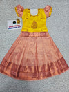 Kids yellow and peach pattu pavadai set with puff sleeve blouse and zari silk skirt from Sri Thulir Tex