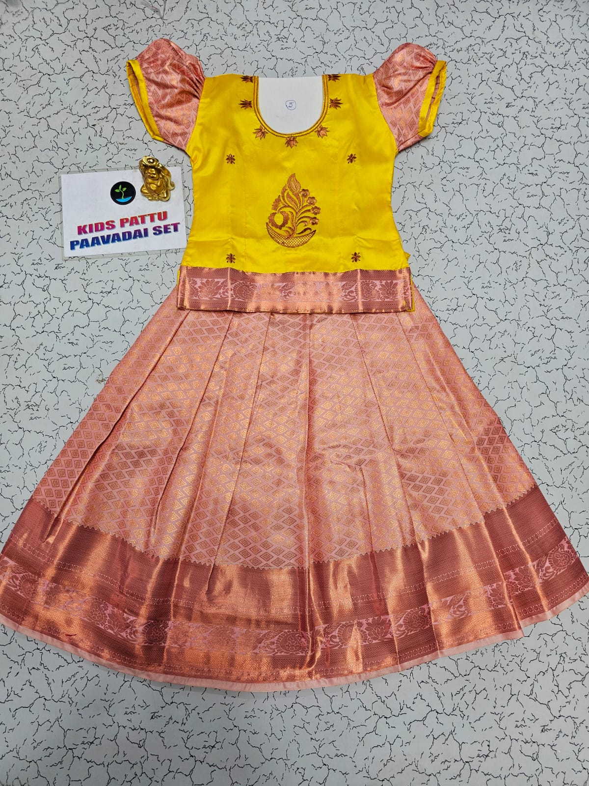 Kids yellow and peach pattu pavadai set with puff sleeve blouse and zari silk skirt from Sri Thulir Tex