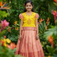 Kids yellow and peach pattu pavadai set with puff sleeve blouse and zari silk skirt from Sri Thulir Tex