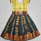 Kids Pattu Pavadai set with yellow stone-work top and dark green zari woven skirt from Sri Thulir Tex.