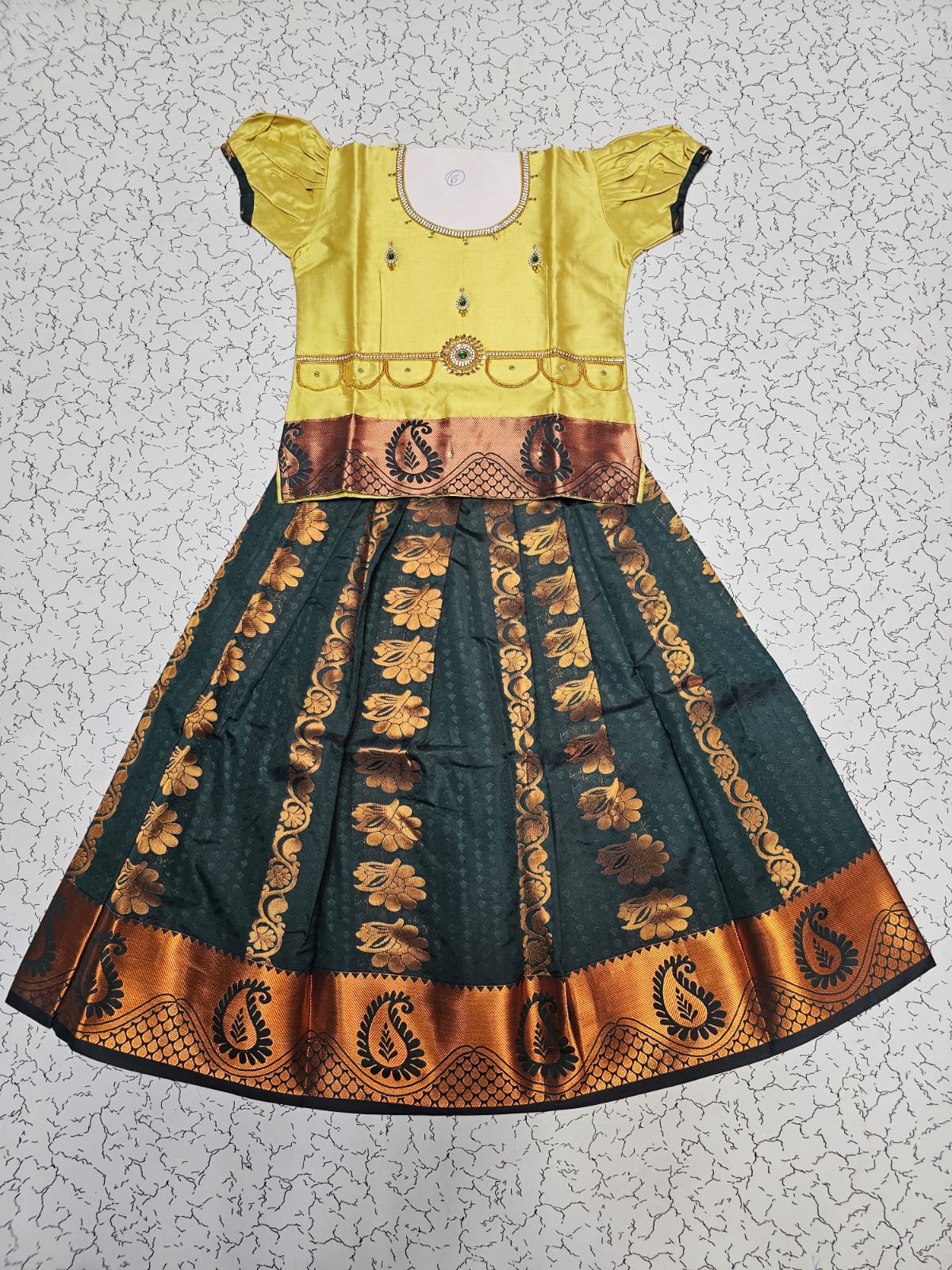 Kids Pattu Pavadai set with yellow stone-work top and dark green zari woven skirt from Sri Thulir Tex.