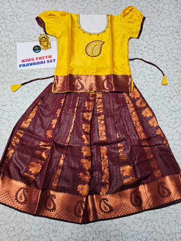 Kids Pattu Pavadai set with yellow stone-work top and maroon zari woven skirt from Sri Thulir Tex.