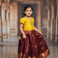 Kids Pattu Pavadai set with yellow stone-work top and maroon zari woven skirt from Sri Thulir Tex.