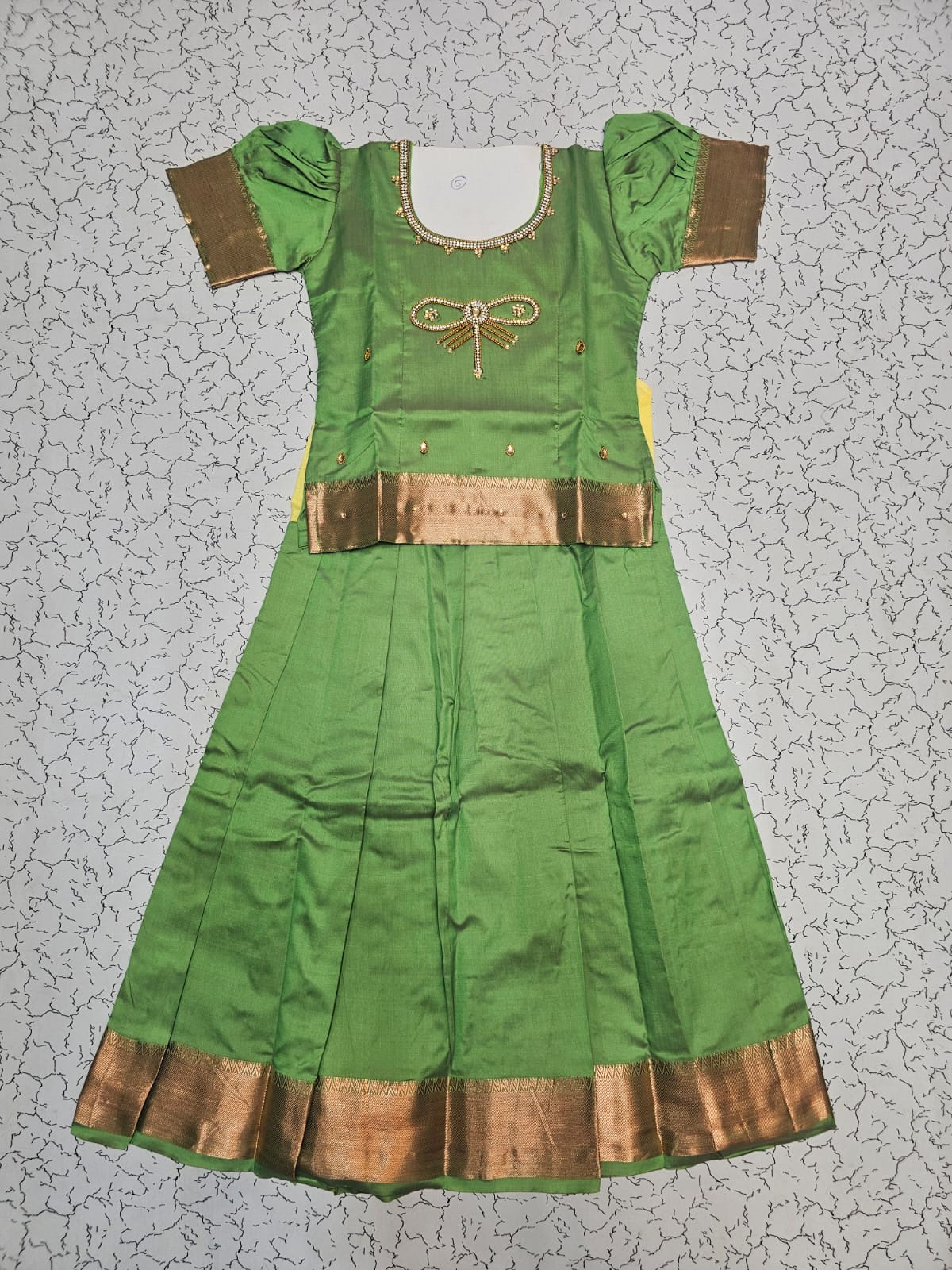 Light green semi silk pattu pavadai for girls with puff sleeves and gold zari border – Sri Thulir Tex
