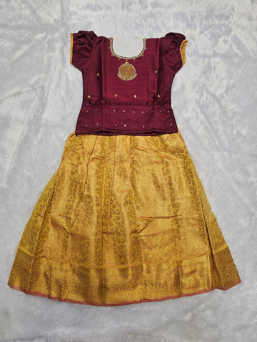 Maroon semi silk top with antique gold bridal silk skirt pattu pavadai for girls featuring puff sleeves and double chain stone neck work, traditional South Indian ethnic wear by Sri Thulir Tex
