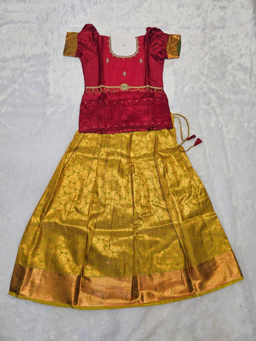 Maroon semi silk top with gold bridal silk skirt pattu pavadai for girls featuring puff hand sleeves, waist belt design and double chain stone neck work by Sri Thulir Tex