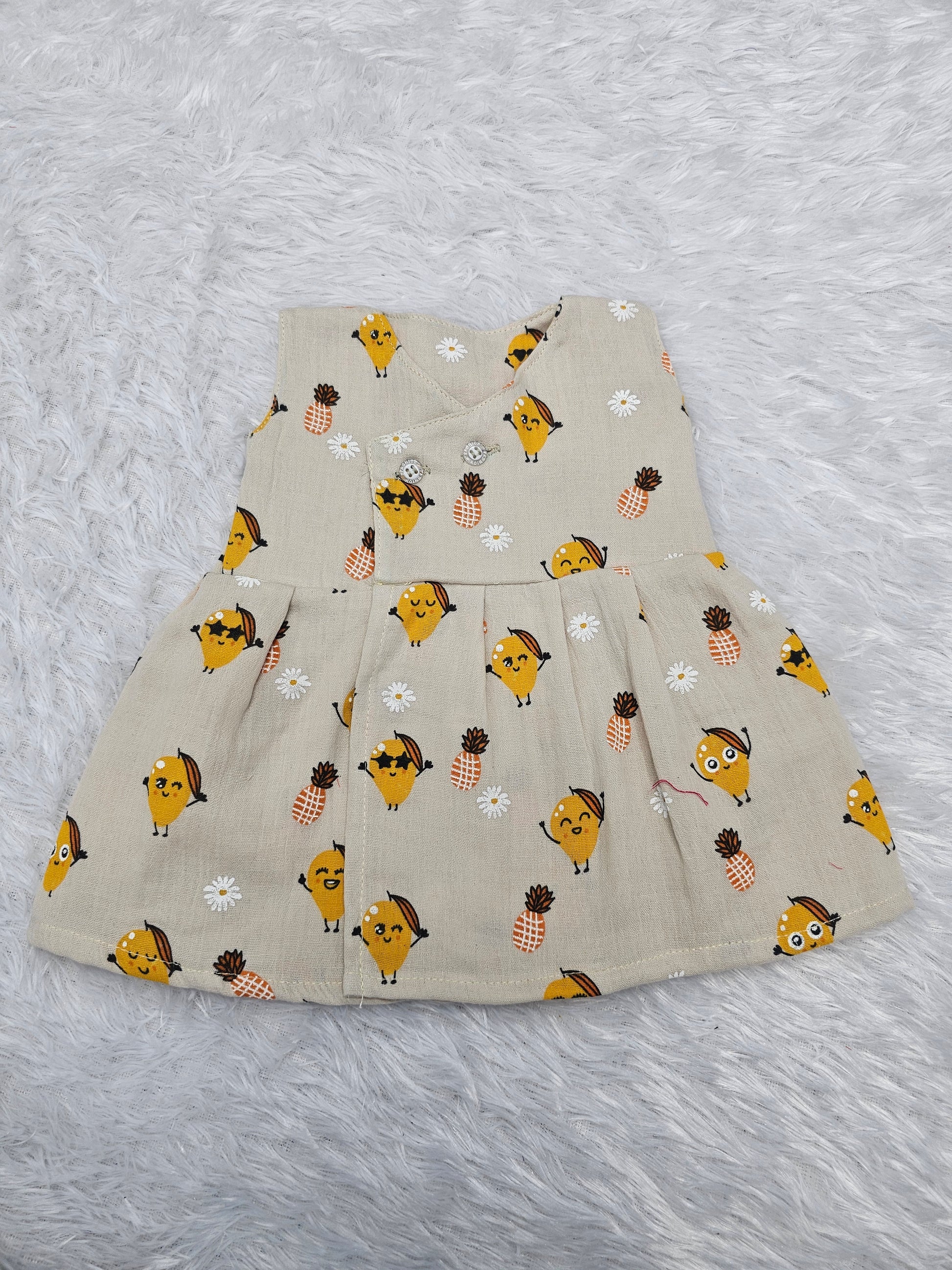 Cream muslin baby jabla frock with cute fruit and pineapple print, front open button style – Sri Thulir Tex