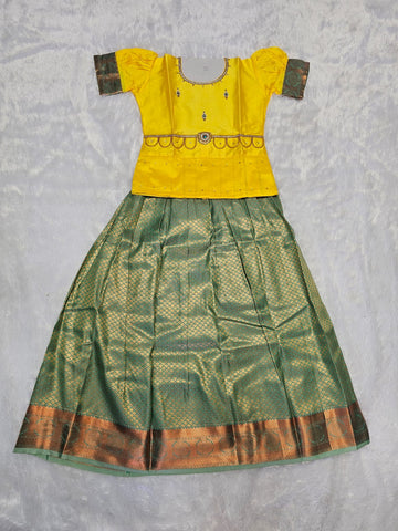 Mustard yellow semi silk top with bottle green bridal silk skirt pattu pavadai for girls featuring puff hand sleeves, waist belt design and double chain stone neck work by Sri Thulir Tex
