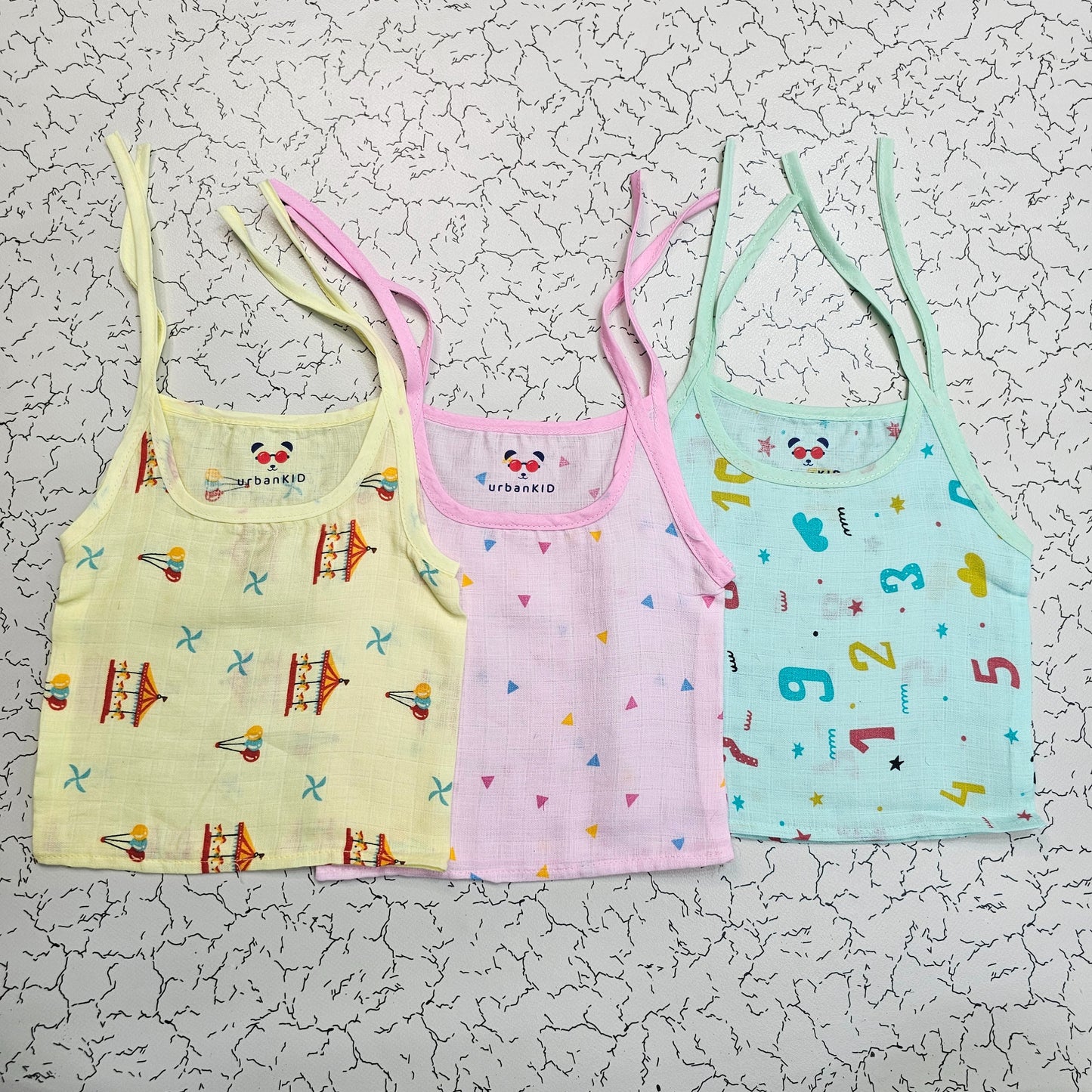 Pack of 3 newborn muslin rope type jabla tops in yellow, peach, and blue with multi printed designs.