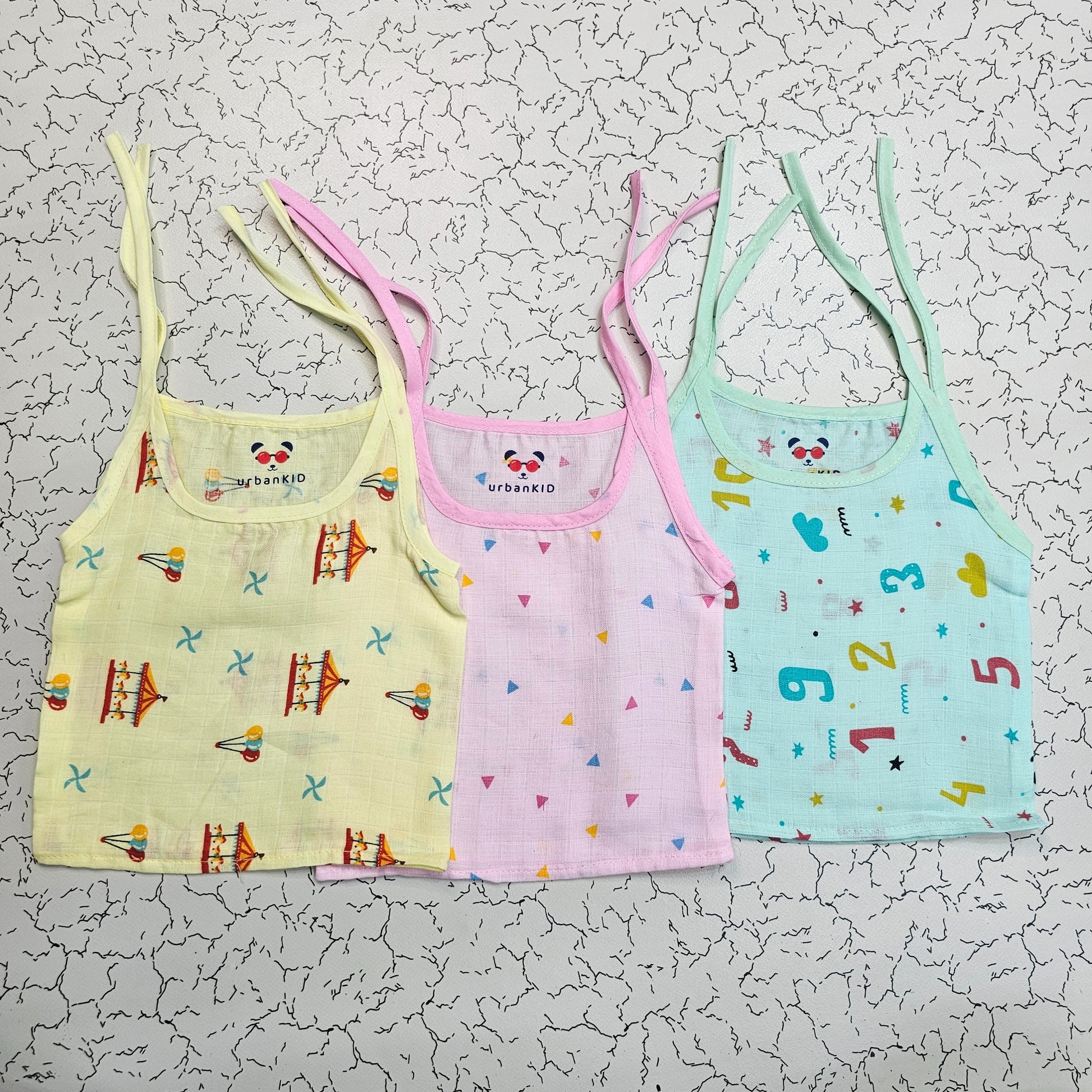 Pack of 3 newborn muslin rope type jabla tops in yellow, peach, and blue with multi printed designs.