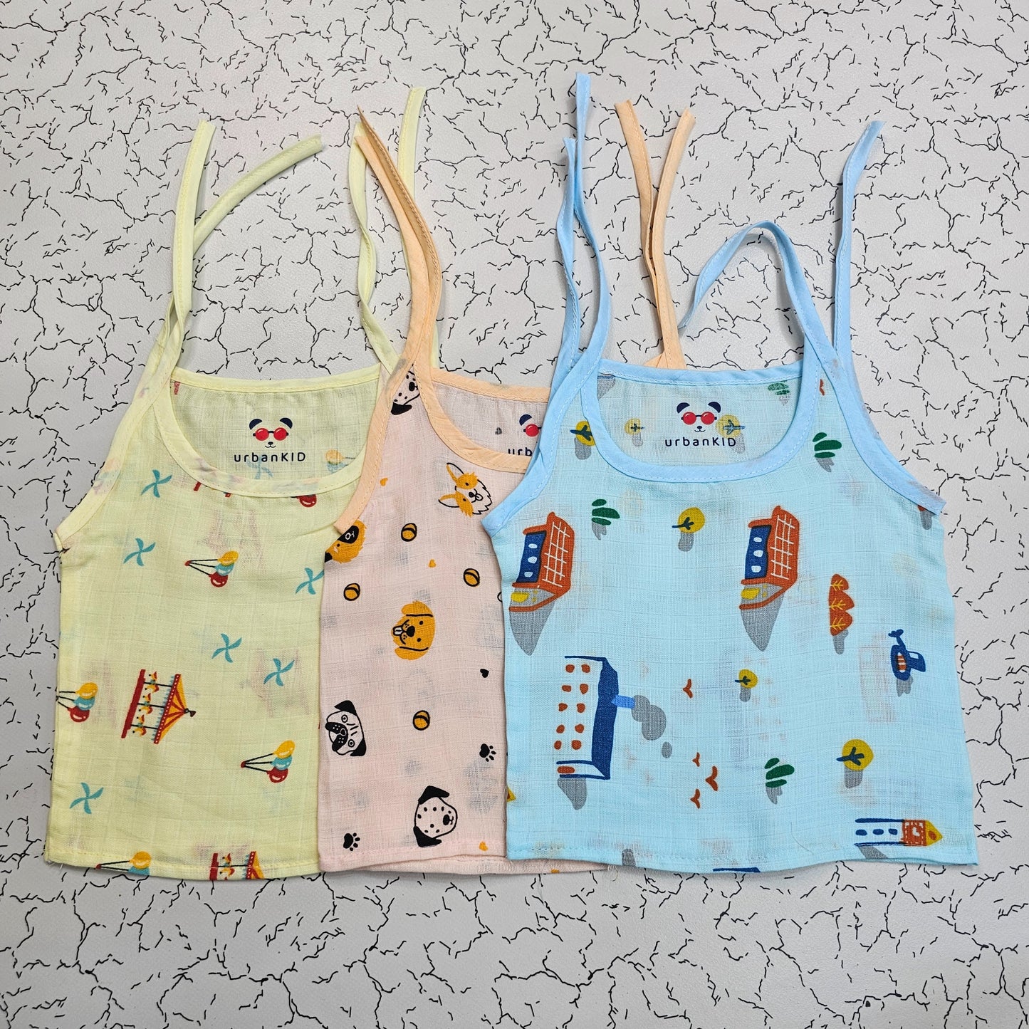 Pack of 3 newborn muslin rope type jabla tops in yellow, peach, and blue with multi printed designs.