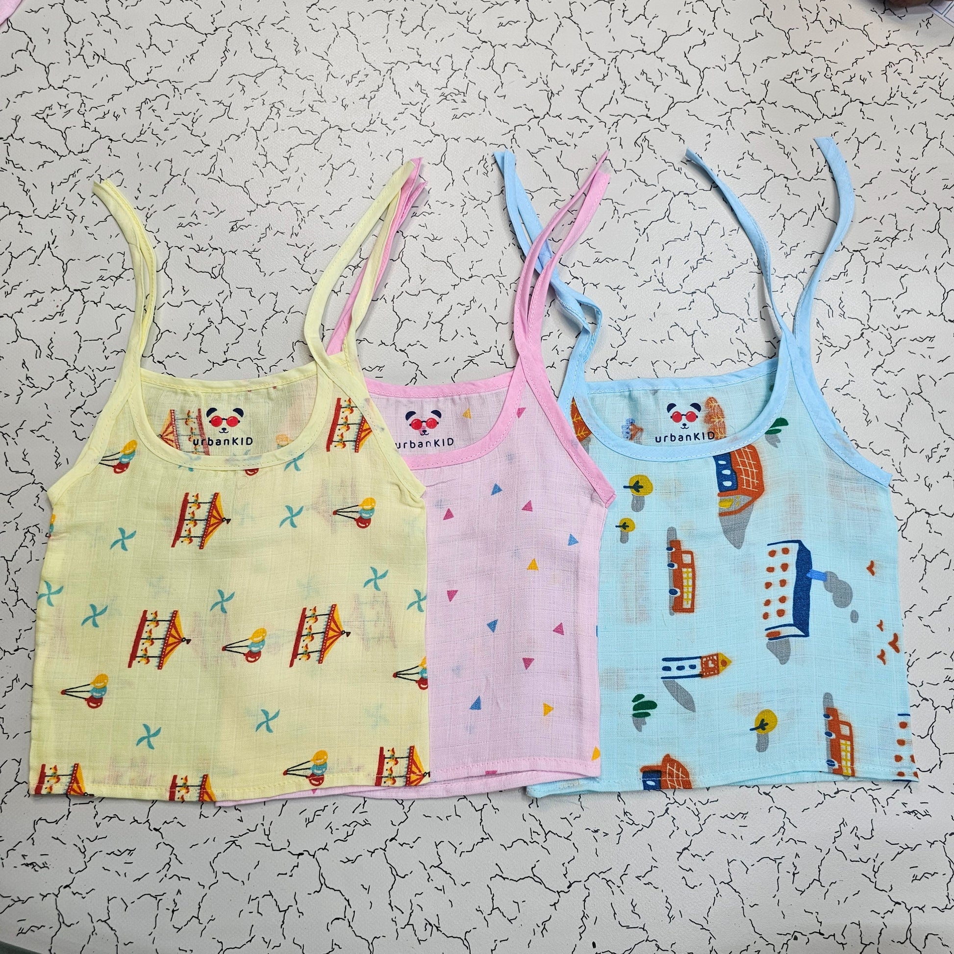 Pack of 3 newborn muslin rope type jabla tops in yellow, peach, and blue with multi printed designs.
