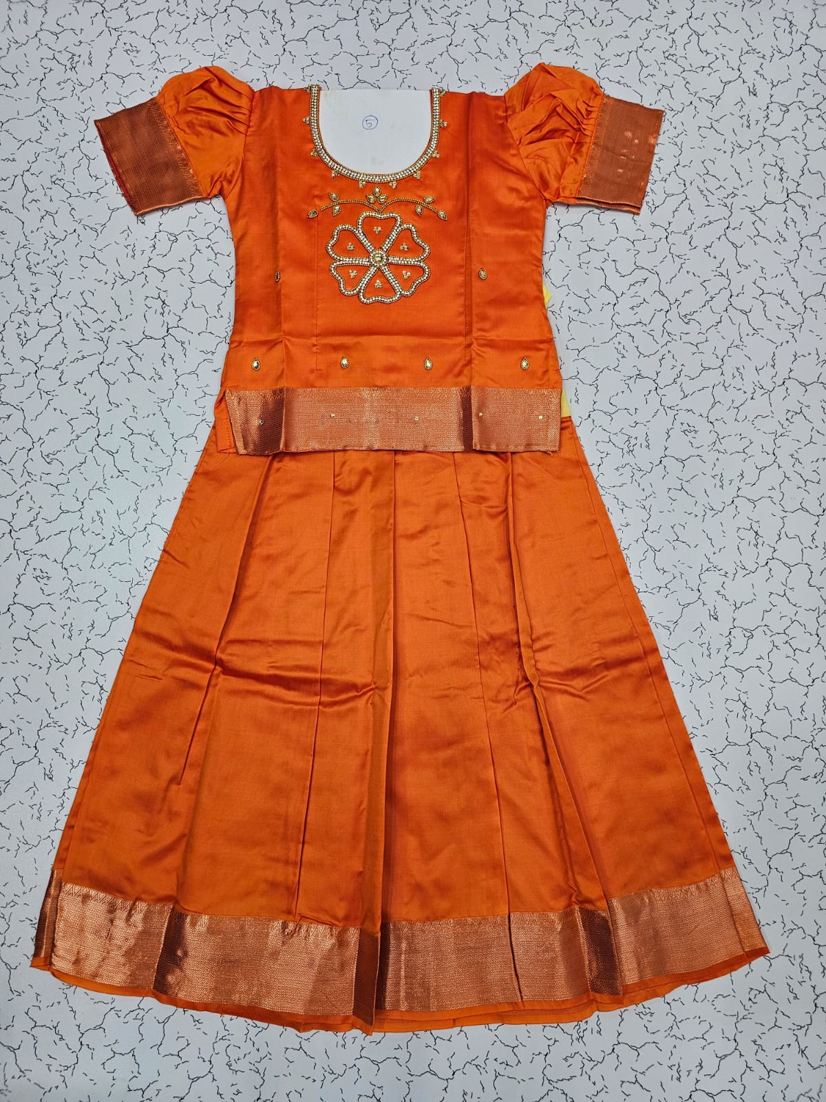 Orange semi silk pattu pavadai for girls with puff sleeve and zari border – Sri Thulir Tex