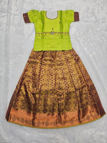 Parrot green semi silk top with antique gold bridal silk skirt pattu pavadai for girls featuring puff hand sleeves, waist belt detailing and double chain neck stone work by Sri Thulir Tex