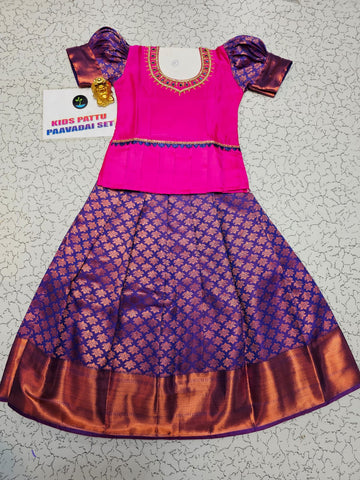 Pink and purple kids pattu pavadai set with puff sleeves and zari woven bridal silk skirt by Sri Thulir Tex